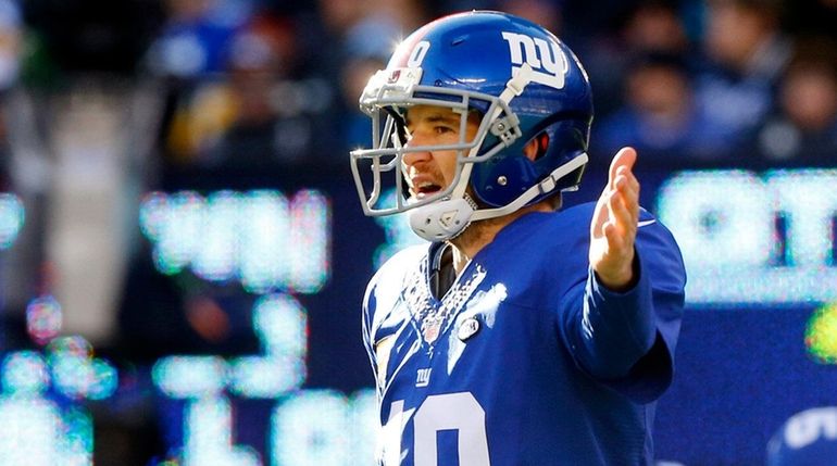 Eli Manning #10 of the New York Giants gestures during...