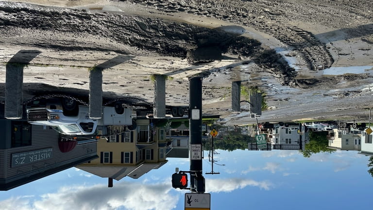 Mud and debris covers roads in Barre, Vt., on Thursday,...