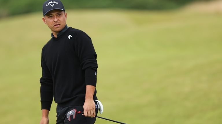 Xander Schauffele of the United States watches his putt on...