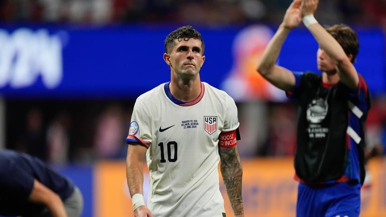 Christian Pulisic of the United States leaves the field after...