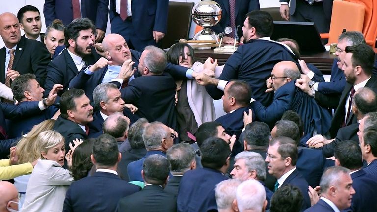 Turkey's ruling AK Party lawmakers scuffle with opposition lawmakers during...