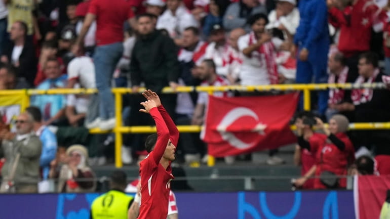 Turkey's Mert Muldur, left, celebrates after scoring his side's opening...