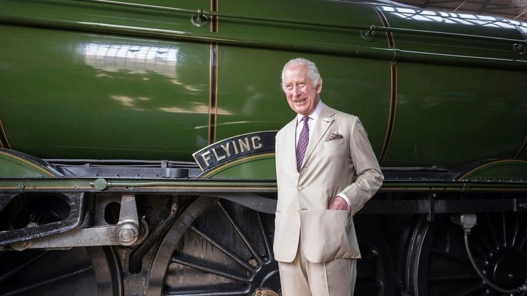 Britain's King Charles III stands by the Flying Scotsman, a...