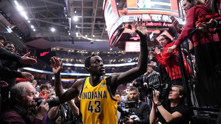 Indiana Pacers' Pascal Siakam greets fans as he comes off...