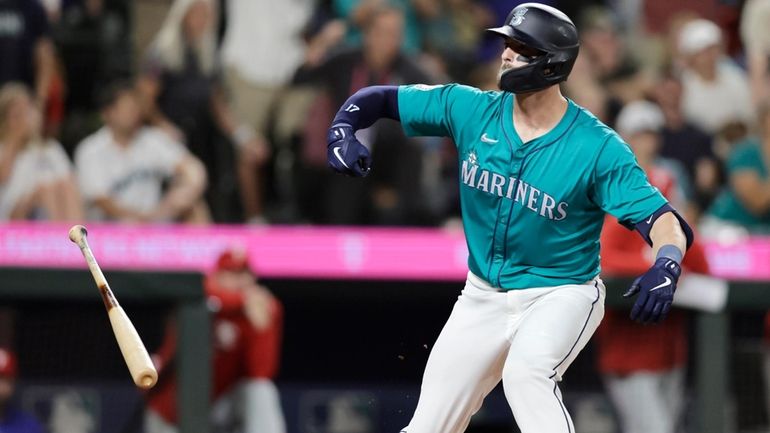 Seattle Mariners' Mitch Haniger reacts after drawing a walk-off walk...