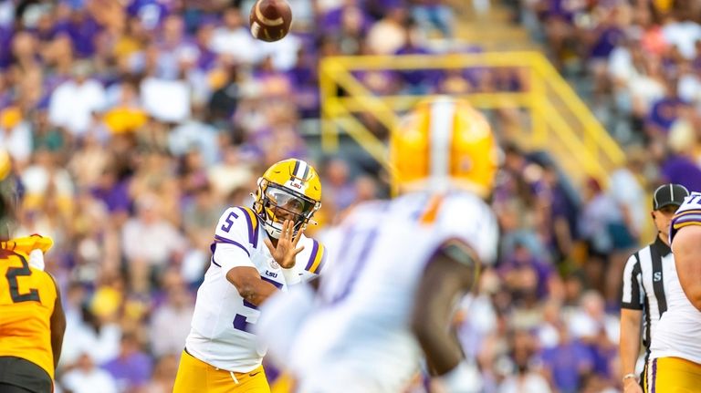 LSU quarterback Jayden Daniels (5) throws a pass against Grambling...