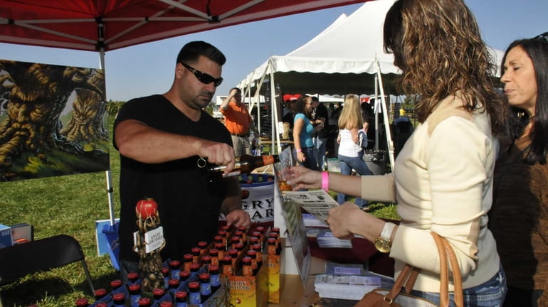 Jon Galeno pours Angry Orchard Hard Cider for attendees at...