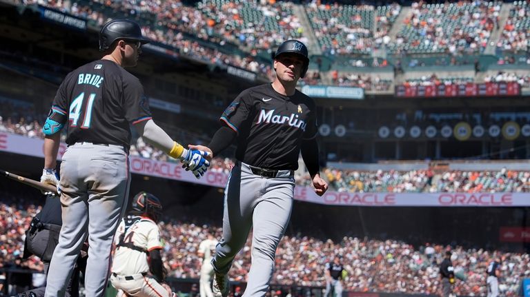 Miami Marlins' Nick Fortes, right, celebrates with Jonah Bride (41)...