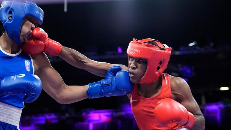 Refugee Olympic Team's Cindy Djankeu hits France's Davina Michel in...