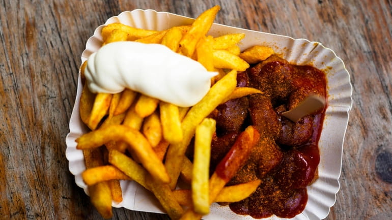 Currywurst, Germany's sausage with curry sauce, served on a cardboard...