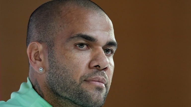Brazil's Dani Alves listens to a question during a press...