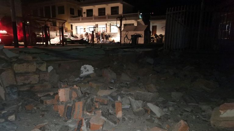 Debris from a wall brought down after an earthquake is...