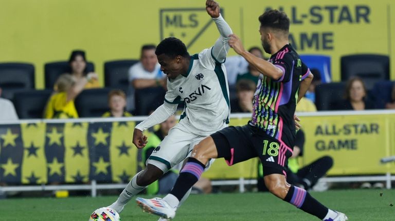 Liga MX All-Stars' Javairo Dilrosun, left, shoots the ball as...