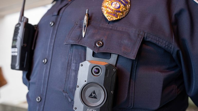 A police officer wears an Axon body camera on March...