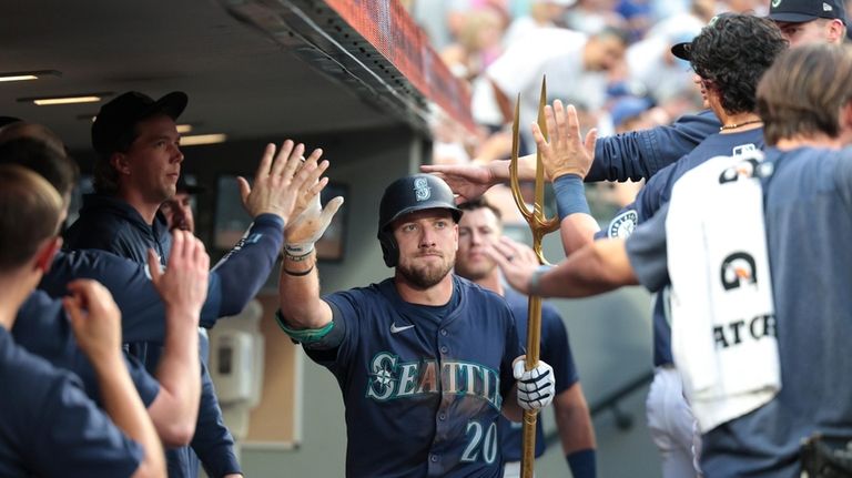 Seattle Mariners first baseman Luke Raley (20) celebrates in the...