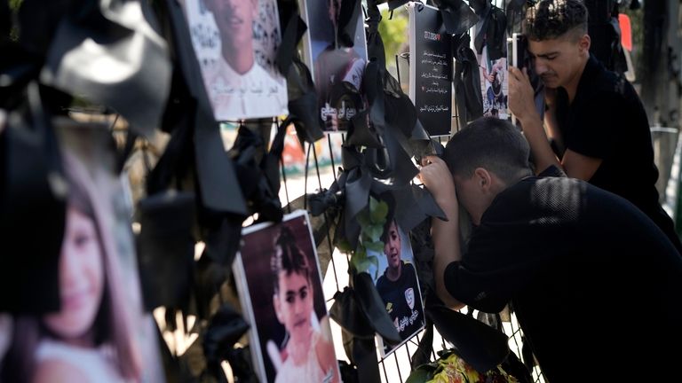 Youths from the Druze minority weep at a makeshift memorial...