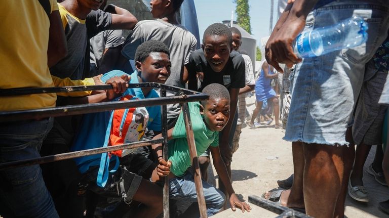 Youth take cover after hearing gunshots at a public school...