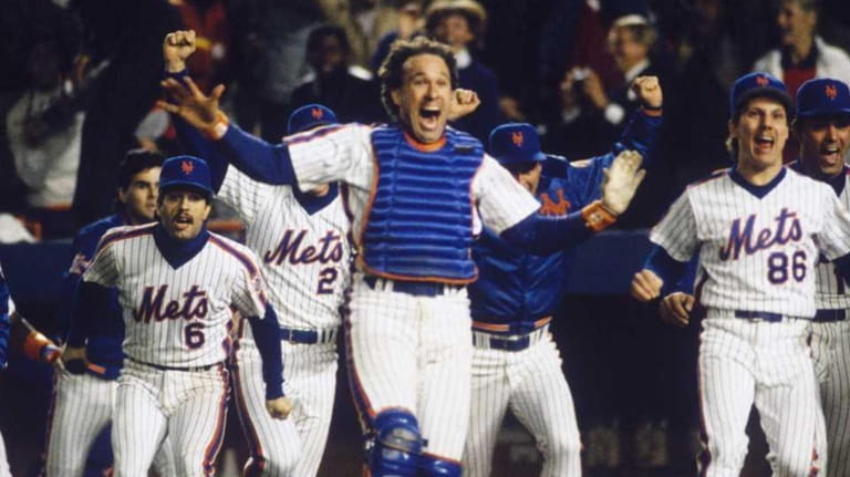 Catcher Gary Carter leads the cheers as the Mets start celebrating...