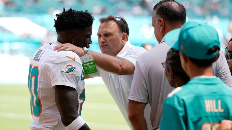 Miami Dolphins wide receiver Tyreek Hill (10) listens to agent...