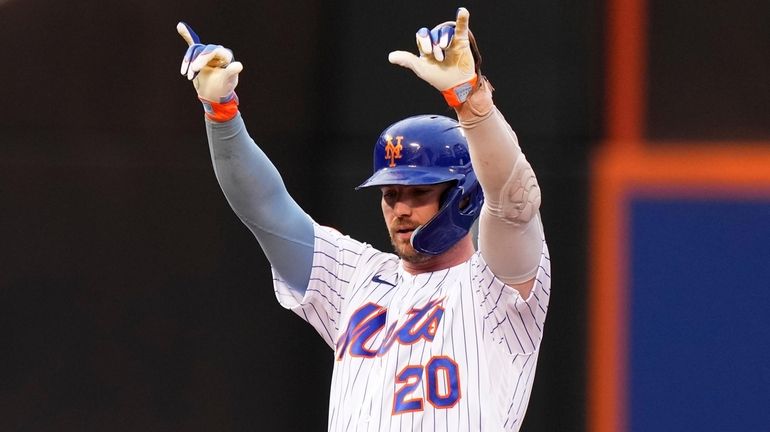 Pete Alonso gestures to Mets teammates after hitting a double...