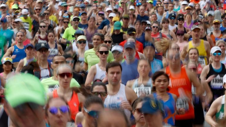 A wave a runners set out from the start of...