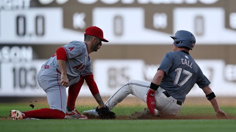 Los Angeles Angels shortstop Zach Neto, left, tags out Washington...