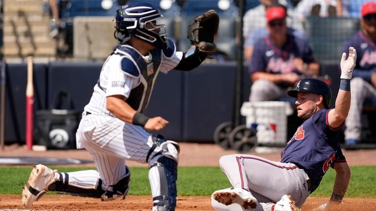 Atlanta Braves' Jarred Kelenic scores as New York Yankees catcher...