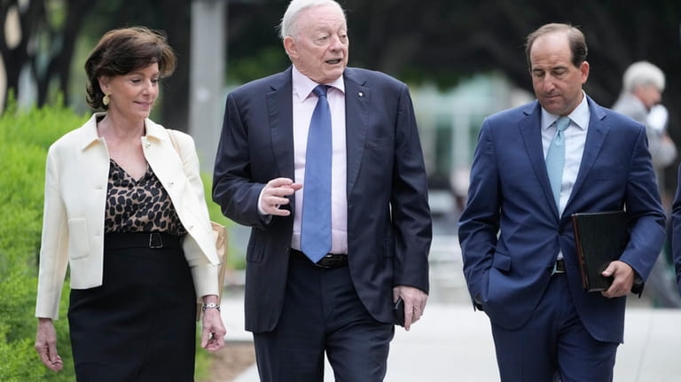 Dallas Cowboys owner Jerry Jones, center, arrives at federal court...