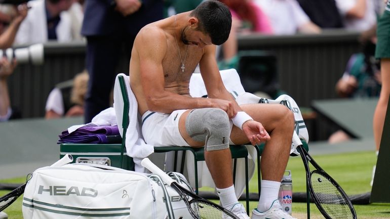 Novak Djokovic of Serbia reacts during a break in his...