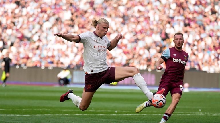 Manchester City's Erling Haaland attempts a shot at goal during...