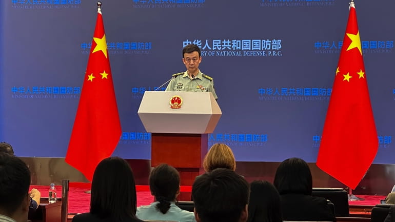 Chinese defense ministry spokesperson Senior Col. Wu Qian speaks during...
