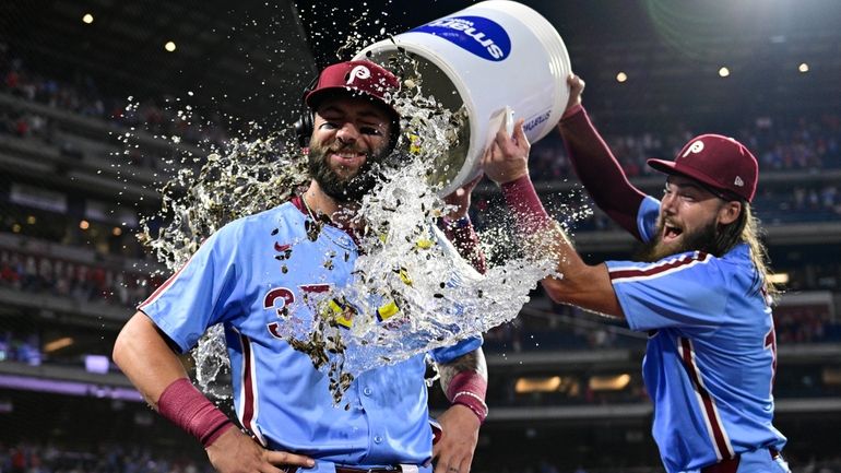 Philadelphia Phillies' Weston Wilson, center, is doused by teammates Brandon...