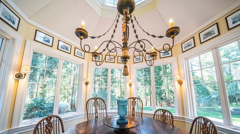 The East Hampton home's breakfast room has screened windows that seem...