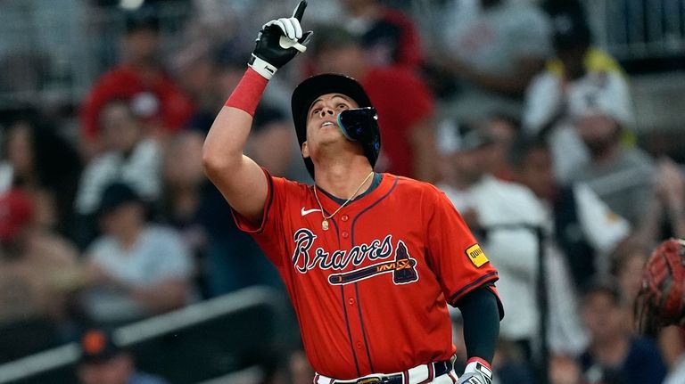 Atlanta Braves' Gio Urshela gestures after driving in a run...