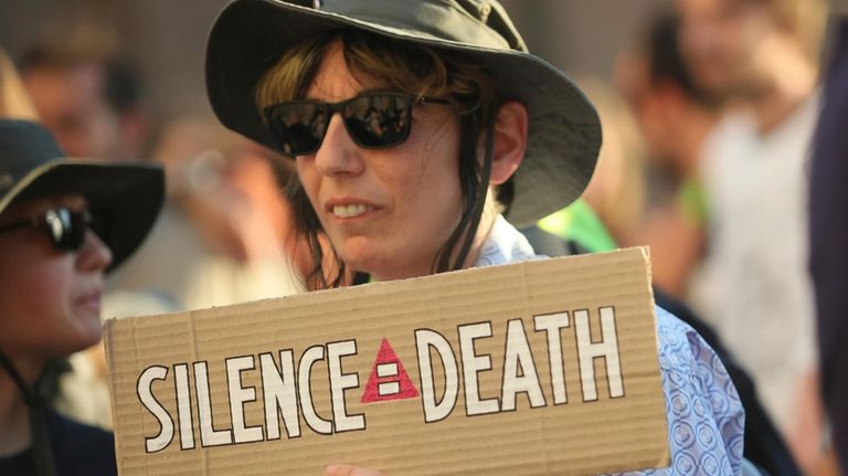 A protester holds a poster during a rally outside Bulgaria's...