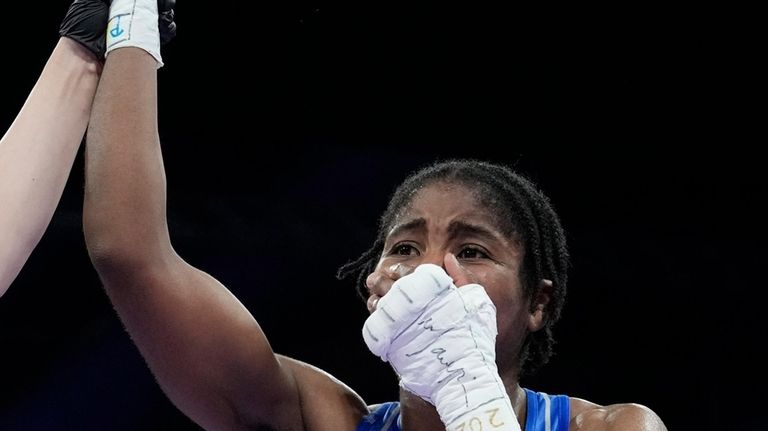 Refugee Olympic Team's Cindy Djankeu celebrates after defeating Canada's Tammara...