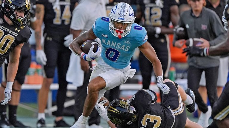 Kansas wide receiver Quentin Skinner (0) gets past Lindenwood linebacker...