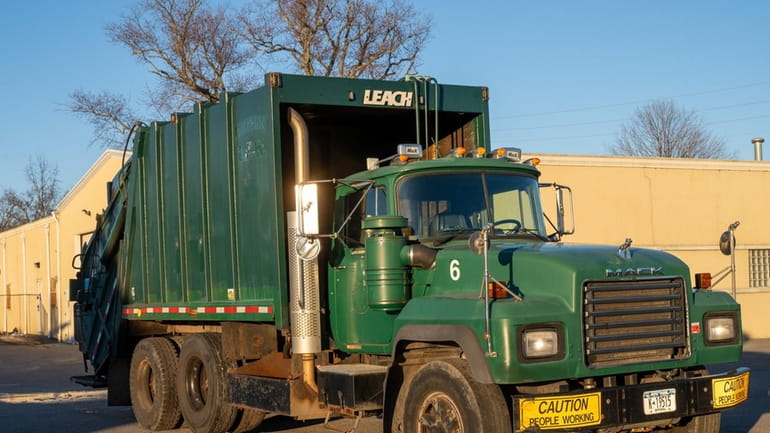 Malverne got $14,000 at auction for a 23-year-old garbage truck.
