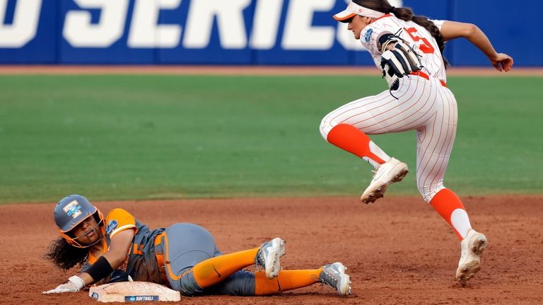 Tennessee's Rylie West, left, steals second base past Oklahoma State's...