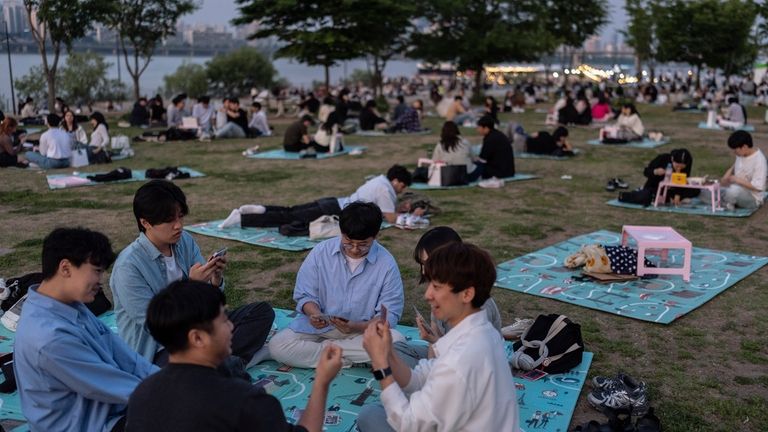 People spend time in Yeouido Hangang Park, a popular destination...