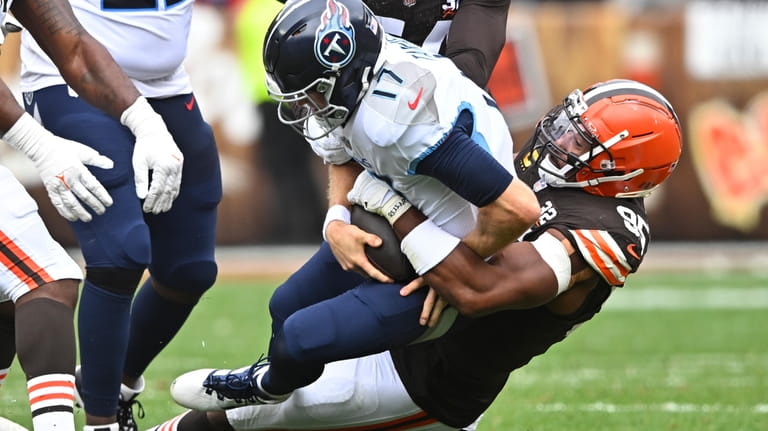 Tennessee Titans quarterback Ryan Tannehill (17) is sacked by Cleveland...