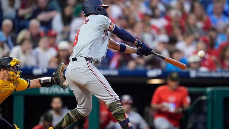 Washington Nationals' Eddie Rosario hits a run-scoring double against Philadelphia...