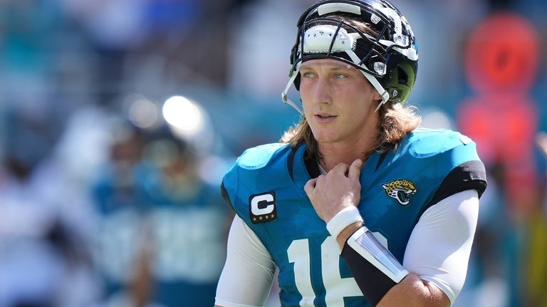 Jacksonville Jaguars quarterback Trevor Lawrence (16) takes a break during...