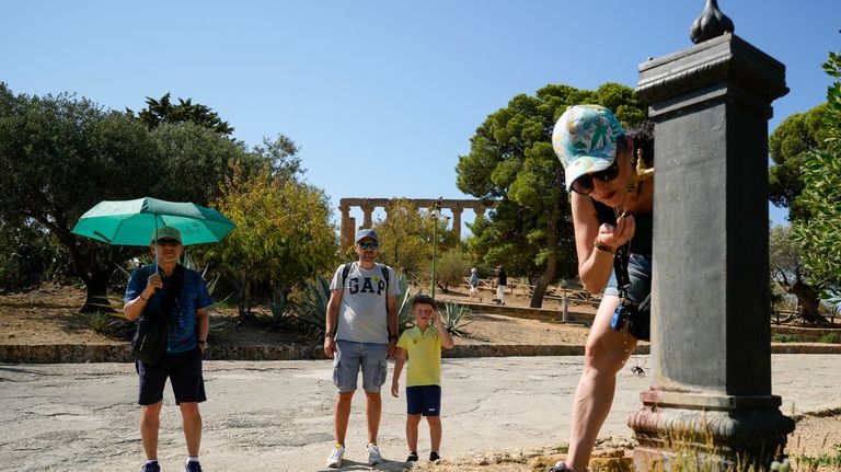 Visitors refresh at a drinking fountain in the Valley of...