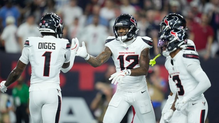 Houston Texans wide receiver Nico Collins (12) is congratulated by...