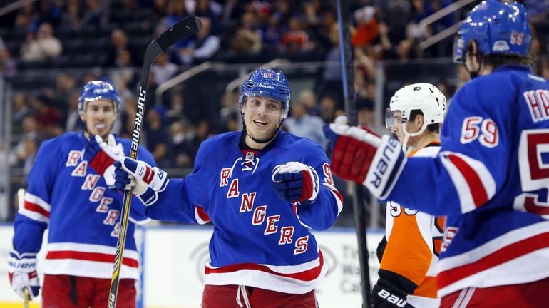 Jesper Fast #91 of the Rangers celebrates his third-period goal...