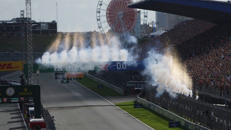 McLaren driver Lando Norris of Britain, bottom, steers his car...