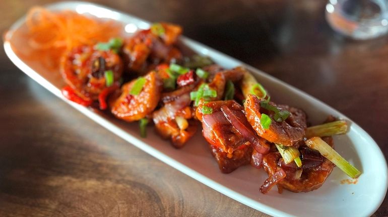 Honey crispy lotus has a sticky sweet chile sauce at...