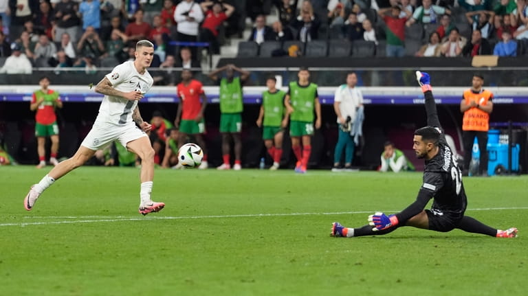 Portugal's goalkeeper Diogo Costa saves a ball by Slovenia's Benjamin...