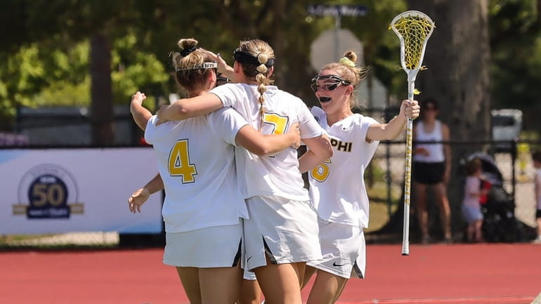 Adelphi players celebrate a goal during their win over of East...